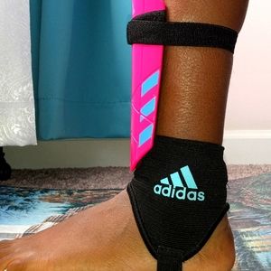 Pink and blue Adidas shin guards size small